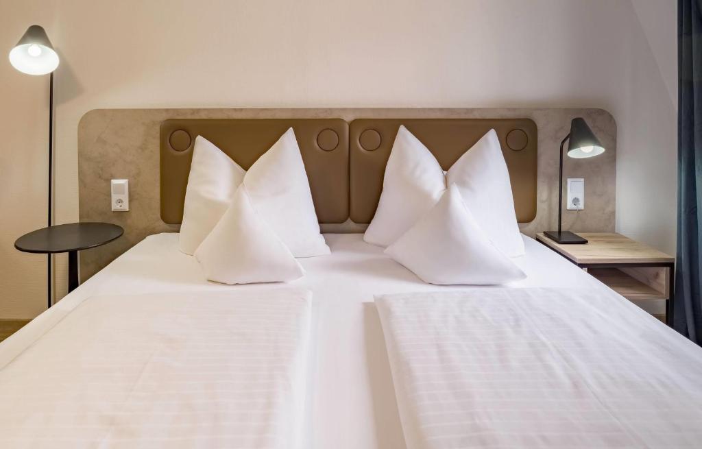 Das Bett eines Doppelzimmers im Aspire Kronprinz 