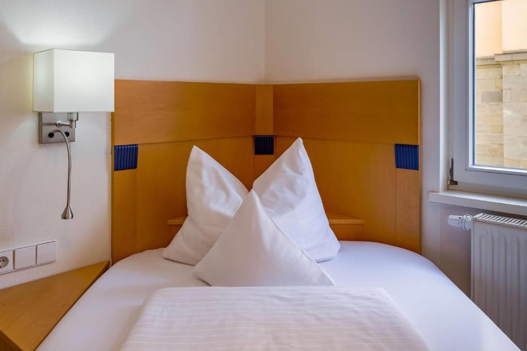 Das Bett im Einzelzimmer im Aspire Kronprinz 