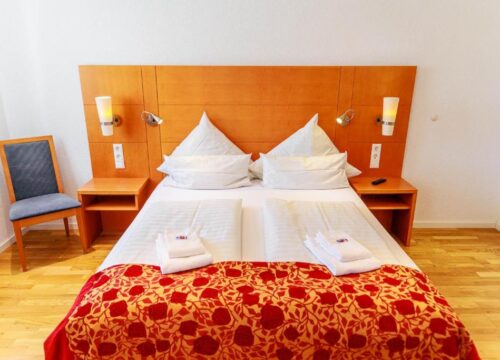 Das Doppelbett und die Nachttische eines Zimmers im Bodensee Hotel Kreuz