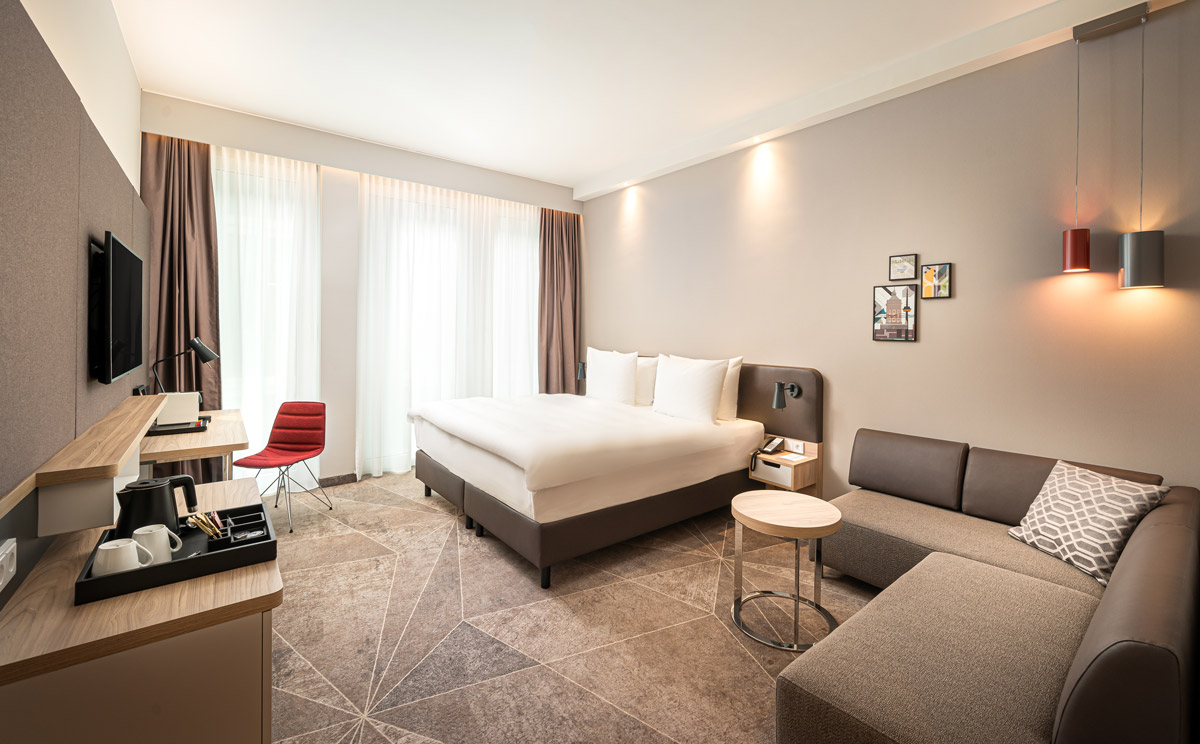 Ein Doppelzimmer mit Sofa und Schreibtisch im Holiday Inn Mannheim