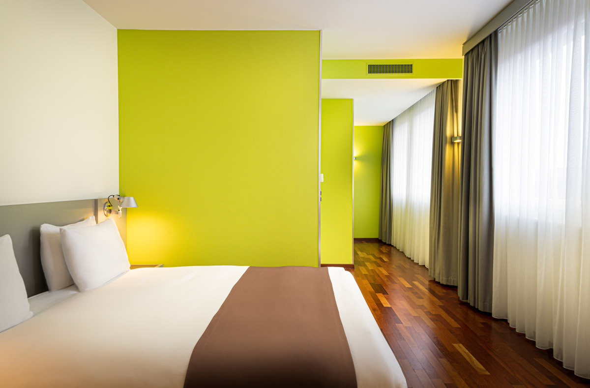Ein Zimmer mit großem Fenster und Doppelbett im Holiday Inn Zürich Messe