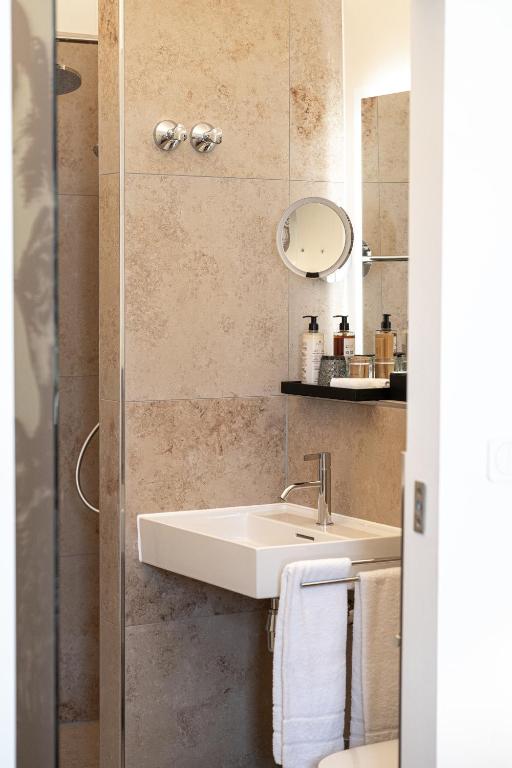 Das Badezimmer mit Waschbecken im Maxim Suites