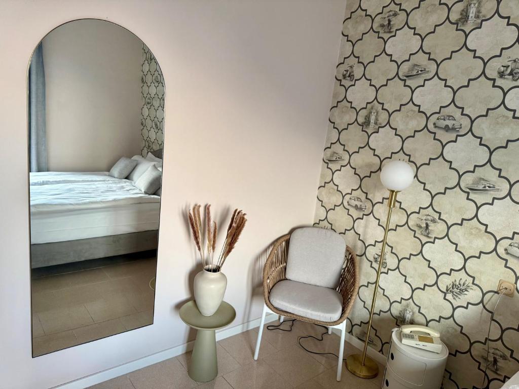 Der Stuhl und Spiegel eines Doppelzimmers im Hotel MioMio